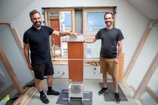 Jonathan Grinham and Jack Alvarenga, two of the team leads, with an evaporative cooling unit as it was installed at HouseZero. Credit: Wyss Institute at Harvard University