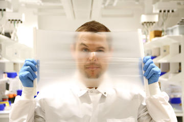 Researcher Peteris Lazovskis holds a dehumidification membrane.