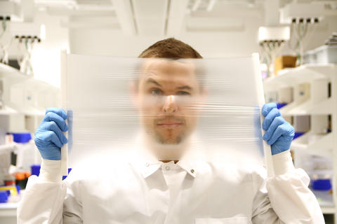 Researcher Peteris Lazovskis holds a dehumidification membrane.